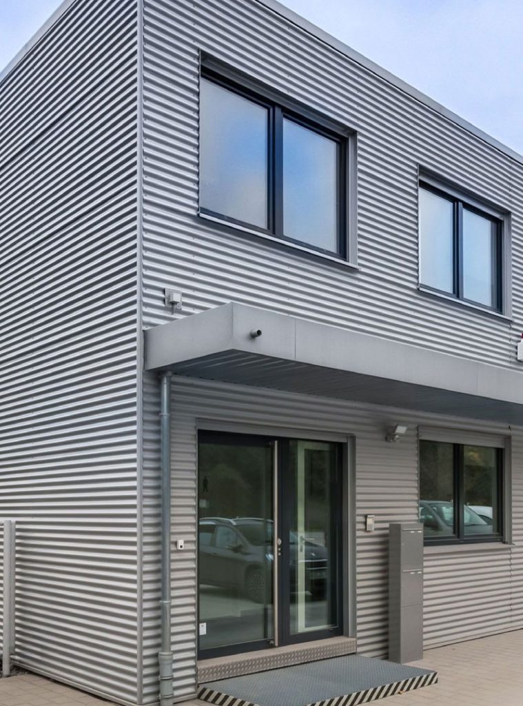 Graues Containergebäude von außen, das als Büro oder Verwaltungsgebäude dient